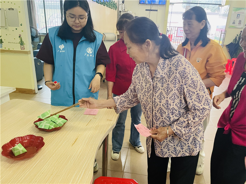 老人們參加“長筷夾粽”游戲現場.jpg